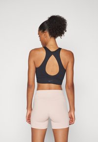 Nike Performance TWIST BRA - Sutiã desportivo de suporte ligeiro - black
