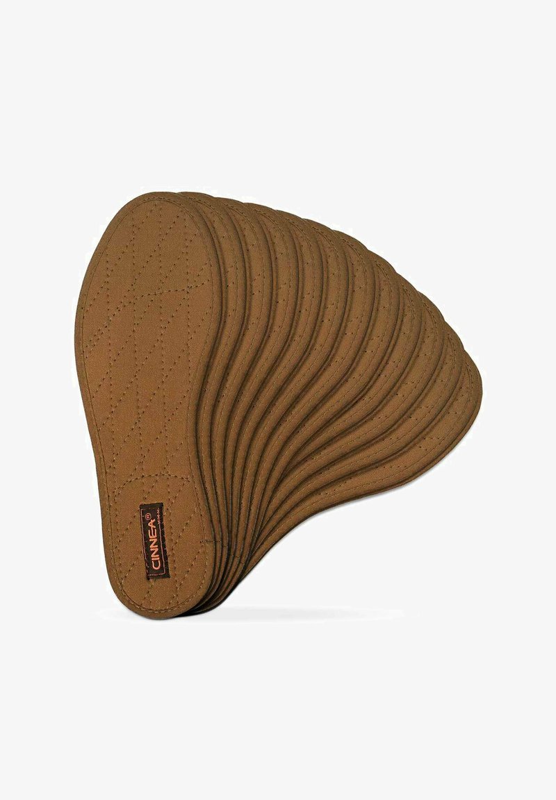 CINNEA quilted brown seat pad with an ergonomic wavy design, featuring a textured surface and subtle stitching detail.