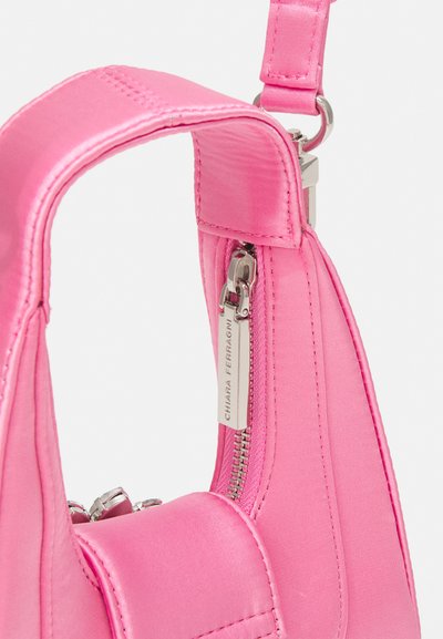 Sac à main en satin rose avec une forme structurée, comportant des accessoires en argent et un compartiment zippé. La sangle est réglable et lisse.