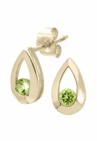 Pendientes en forma de lágrima de oro con una piedra preciosa verde en la base. Superficie suave con un acabado pulido y un sutil diseño recortado.