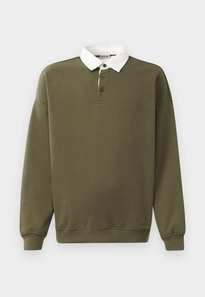 Olíva zöld pulóver, fehér gallérral, három gombos nyakkivágással, hosszú ujjakkal, bordás mandzsettákkal és aljjal. Puha tapintású.