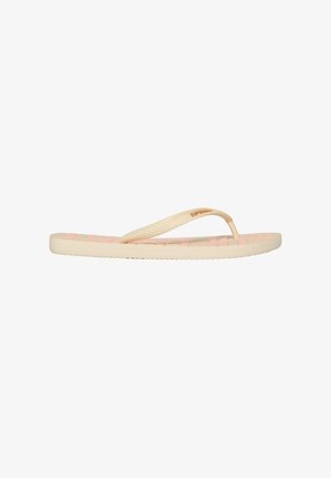 Chanclas beige con una plantilla texturizada y correas de goma. Presentan sutiles acentos rosas y un logo en la correa. Suela plana.