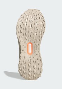 Béžová pryžová podrážka topánky s hlbokými zárezmi, oranžovým oválnym prvkom označeným "TORSION SYSTEM" a označením "Continental WinterGrip".