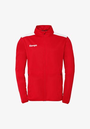 Rode sportjack met witte schouderaccenten en een hoge kraag. Bevat ritsen op de zijzakken en een wit "Kempa" logo op de borst.