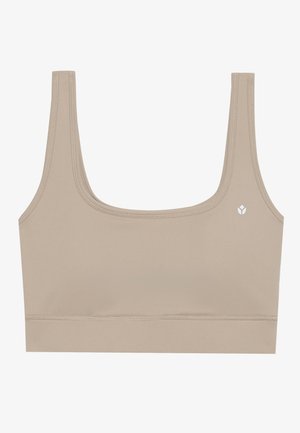 Beige bralette med u-formet hals, tykke stropper og en tettsittende design. Har en liten hvit logo på venstre side. Glatt tekstur.