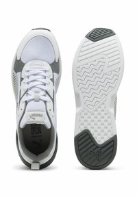 White athletic shoes with gray accents, breathable mesh, and a textured rubber sole featuring a zigzag pattern and logo details.