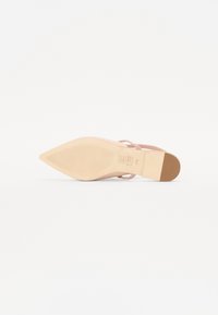 Pointed-toe, blush pink shoe with a smooth leather upper, slim ankle strap, and a light brown rubber sole featuring ridges for grip.