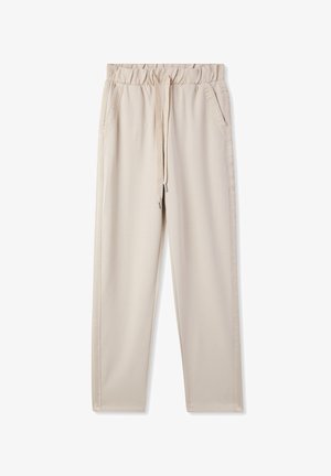 Pantaloni jogger beige con vita elasticizzata, coulisse, tasche laterali e gambe affusolate. Realizzati in un tessuto morbido ed elastico con una superficie liscia.