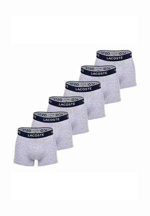 Gray cotton boxer shorts featuring a navy waistband with "LACOSTE" logo. Five pairs arranged in a row, showcasing their consistent design.