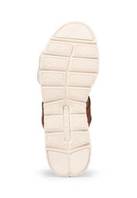 Brun gummisul med ett strukturerat greppmönster, med vita accenter och en märkesdel som läser "Cole Haan" i mitten.