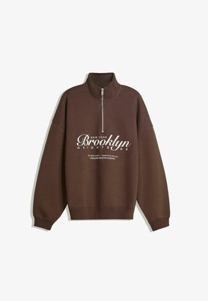 Brown sweatshirt with a high collar and quarter-zip. Features white printed text: "NEW YORK Brooklyn Heights 98" and a soft texture.