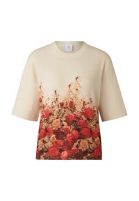 Kremowy t-shirt z krótkim rękawem o prążkowanej fakturze, z kwiatowym nadrukiem w czerwieni i beżu na dole, okrągły dekolt, luźny krój.