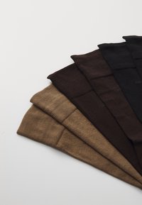 Five pairs of socks in varying shades of brown, with a ribbed texture, featuring smooth cuffs and a simple design on a light background.