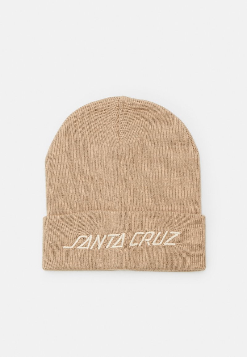 Bonnet beige en tricot avec bord replié, arborant un texte brodé blanc "SANTA CRUZ" sur le devant.