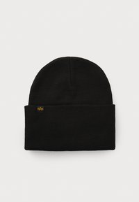 Black knitted beanie with a ribbed cuff. Features a small yellow logo tag on the front. Soft texture and rounded top design.