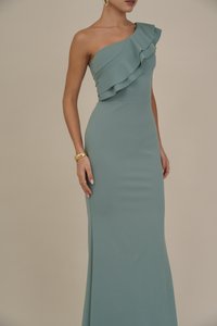 One-shoulder gown in light teal, featuring a ruffled neckline and fitted silhouette, crafted from soft, smooth fabric with subtle sheen.