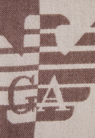 Tissu brun et crème à motif featuring des lettres et des formes stylisées, avec un tissage texturé, créant un contraste visuel dynamique.