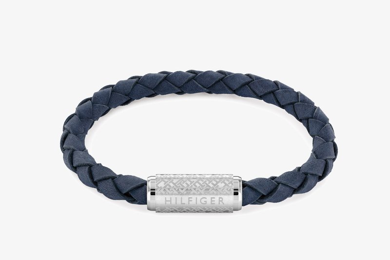 Navy blue braided leather bracelet with a silver cylindrical clasp, featuring an intricate patterned surface and engraved "HILFIGER" text.
