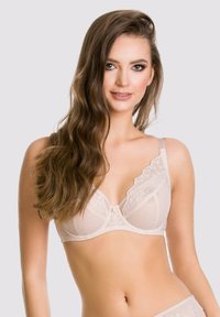 Beżowy biustonosz koronkowy z przezroczystymi wstawkami, haftowanymi detalami, wsparciem w postaci fiszbin, regulowanymi ramiączkami oraz z zapięciem na haftkę z tyłu.