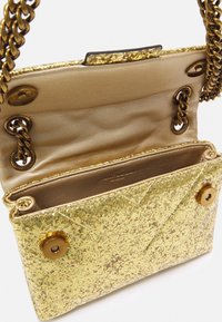 Golden glitter handbag with a chain strap, textured exterior, and gold-toned hardware. Interior features a shiny gold lining and pockets.