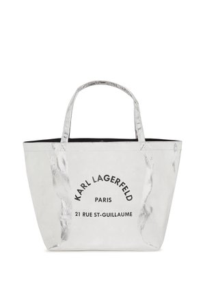 Silver tote bag with two handles, featuring a black interior, smooth texture, and printed text: "KARL LAGERFELD PARIS 21 RUE ST-GUILLAUME."