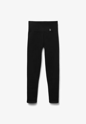 Leggings noirs en tissu extensible, dotés d'une taille large et d'une coupe ajustée, sans motifs ni accents visibles.