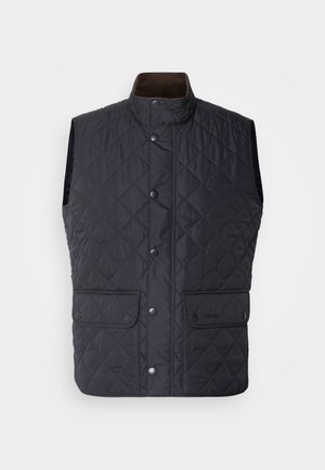 Navy quilted vest with a high collar, snap buttons, and two front pockets. Features a smooth texture and a classic, insulated design.