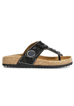 Svart pärlflip-flop sandal med en korkfotbädd och svart gummisula. Har dekorativa stenar och en tångremdesign.