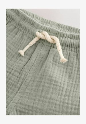 Lichtgroene katoenen korte broek met een gestructureerde afwerking. Voorzien van een elastische tailleband en een crèmekleurige trekkoord met een knoop.
