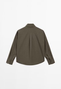 Long-sleeve shirt in a dark olive green color, featuring a pointed collar, button cuffs, and a pleat at the back for added texture.