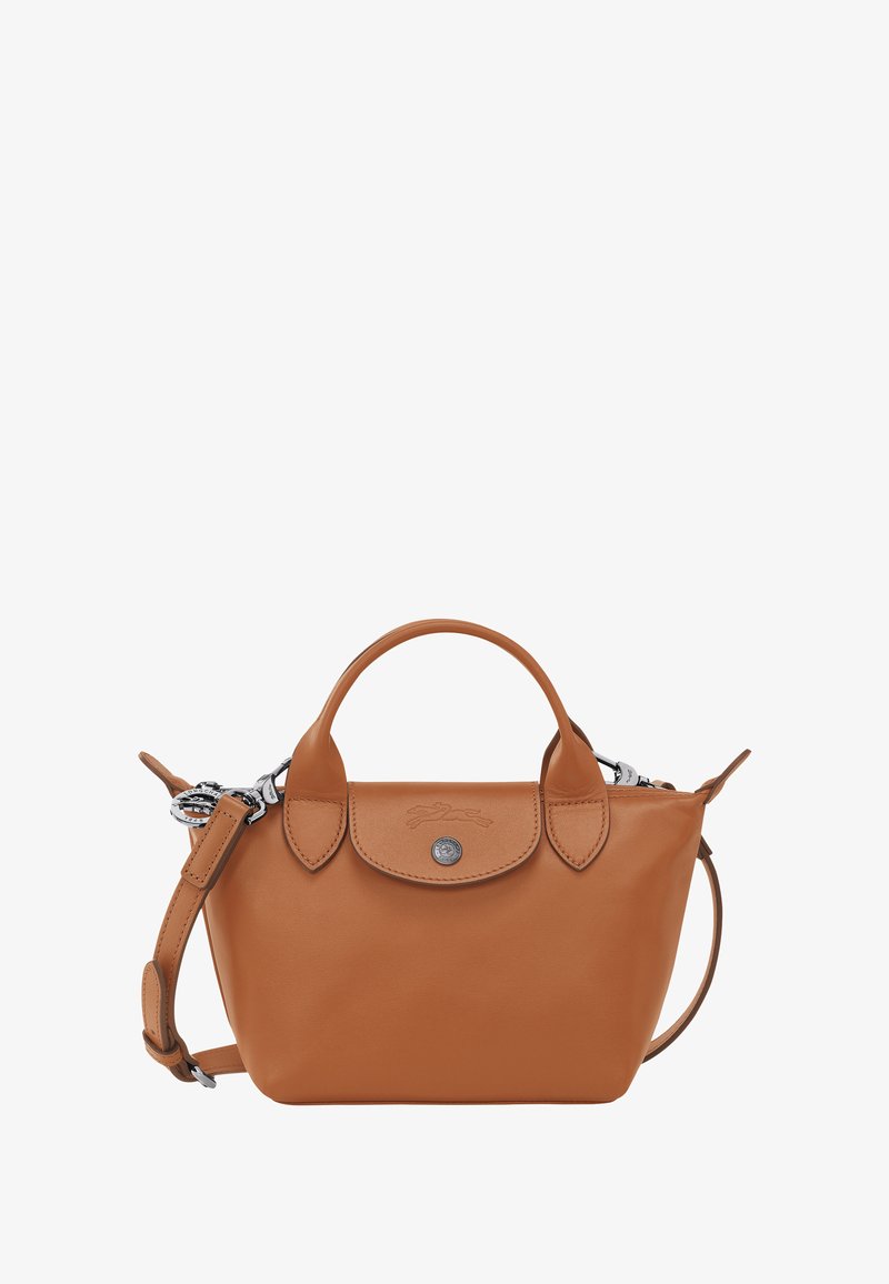Tan leather handbag with rounded shape, short handles, and a detachable shoulder strap. Features a silver button and embossed logo.