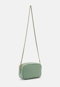 Quilted synthetic green crossbody bag with a gold chain strap. Rectangular shape, zip closure, decorative stitching, and rounded edges.