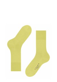 Żółte bawełniane skarpetki o gładkiej fakturze, z długością do kostek i prążkowanym ściągaczem. Markowy logotyp jest nadrukowany na podeszwie.