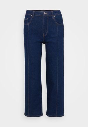 Jeans ampi di colore blu scuro realizzati in denim, con zip frontale, chiusura con bottone metallico e cuciture arancioni a contrasto sui bordi.