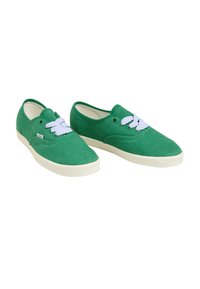 Green canvas sneakers with white laces, rounded toe, textured upper, and a beige rubber sole, featuring a stitched logo on the side.