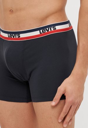 Boxers de color azul oscuro con un ajuste ceñido, featuring una cinturilla blanca acentuada con rayas rojas y navy, y el logo de "Levi's" mostrado de manera prominente.