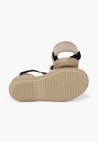Sandalo espadrilla beige con tomaia in rete, cinturini neri, suola in corda intrecciata, fondo testurizzato e indicazione della taglia. Design piatto e aperto.