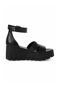 Zwarte platformsandalen met een dikke zool, voorzien van glad leren bandjes en een verstelbare enkelband. Gestructureerde zool voor grip.