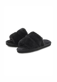 Black fur-lined slide slippers with two wide, plush straps and a textured footbed. Soft material and flat, rubber soles for indoor comfort.