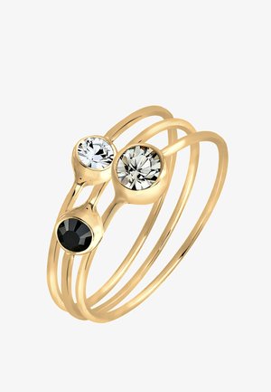 Goldfarbener Ring mit drei runden Edelsteinen: zwei klare und einen schwarzen. Glatte, dünne Bänder winden sich für ein modernes Design.