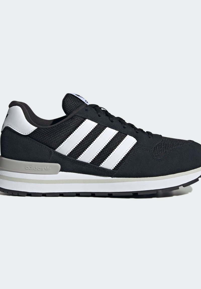 Black and white Adidas sneaker with three white stripes, mesh and suede upper, and cushioned sole on neutral background.