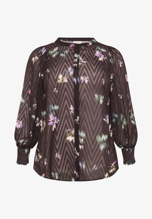 Blusa nera trasparente con motivo floreale, maniche lunghe a palloncino, chiusura frontale con bottoni e polsini elasticizzati. Design a zigzag testurizzato su tutta la superficie.