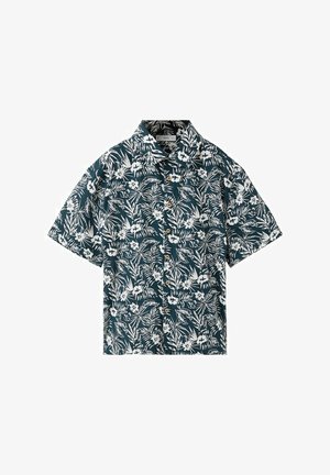 Chemise à manches courtes boutonnée avec un fond vert foncé et un imprimé floral tropical blanc et feuilles.