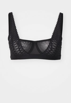 Juodas braletė su permatomu tinkleliu, nėrinių apdaila kraštuose ir plačiomis petnešomis. Paprastas dizainas be rėmelio.