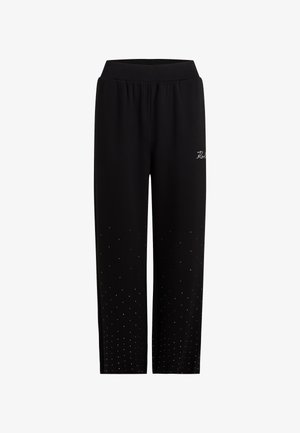 Schwarze Jogginghose mit elastischem Bund, die ein dezentes Logo zeigt und entlang der unteren Beine mit kleinen Strasssteinen verziert ist.