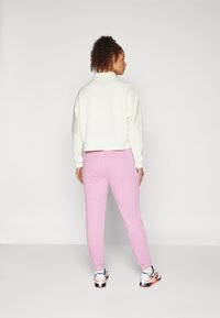 Reebok FRENCH TERRY - Tepláky - rose