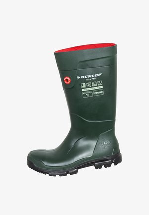 Grüner Gummistiefel mit rotem Innenfutter, ausgestattet mit einer strukturierten Oberfläche, verstärkter Zehenpartie und gezackter Außensohle für guten Halt. Branding an der Seite.