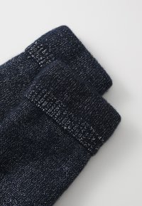 Dark navy socks with a textured finish, featuring a ribbed cuff and fine metallic threads woven throughout for added detail.