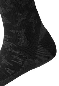 Calcetines negros con un sutil patrón oscuro, con talón y puntera reforzados, hechos de un material suave y elástico para mayor comodidad y ajuste.