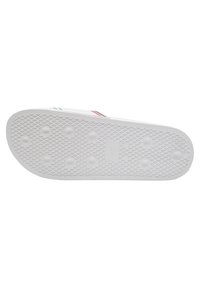Semelle de chaussure en caoutchouc blanc avec un motif texturé, comportant des grips circulaires et une étiquette de taille "42". Trois bandes d'accent en bleu, vert et rouge.